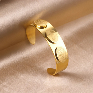 Elegant Gold-Tone Cuff Bracelet with Intricate Design