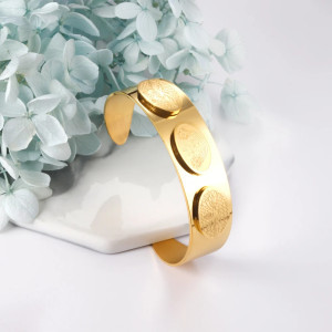 Elegant Gold-Tone Cuff Bracelet with Intricate Design